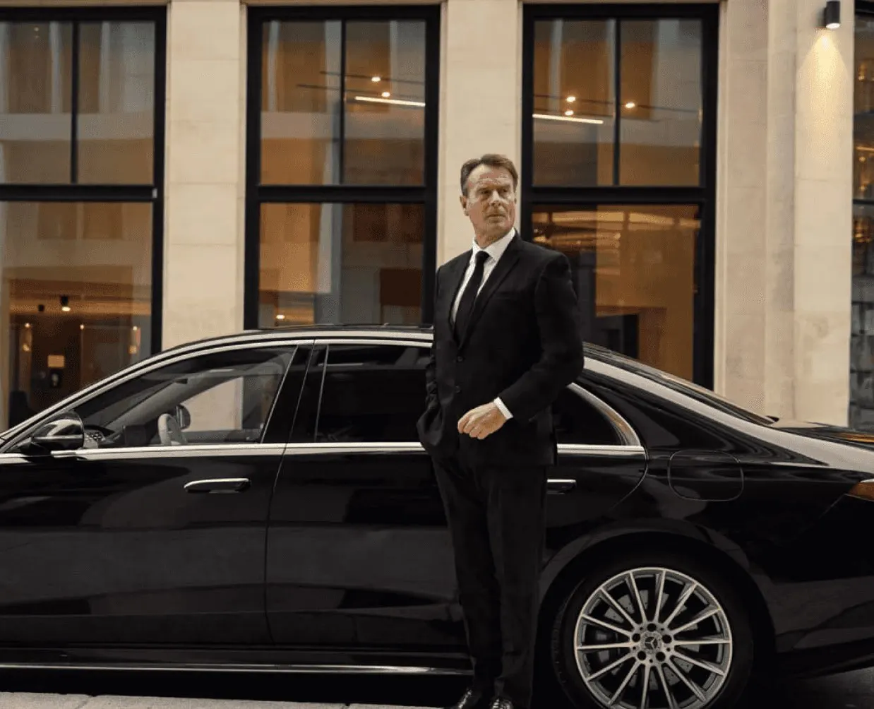 Executive Chauffeur Opening Luxury Sedan Door